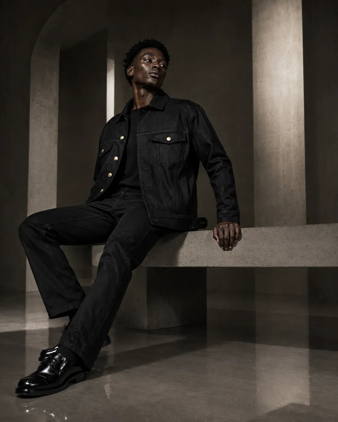 Lover Boy Jean Jacket and Jeans in black, against concrete arches.